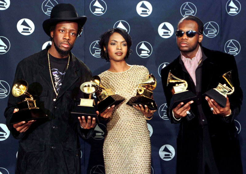 The Fugees (from left) Wyclef Jean, Lauryn Hill and Prakazrel Michel pose with the Grammy they won for the Best R & B Performance by a Duo or Group for "Killing Me Softly With His Song" at the 39th Grammy Awards at Madison Square Garden in New York February 30.